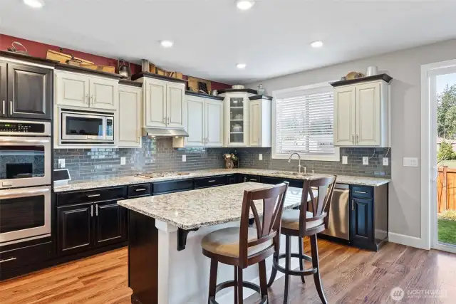 Double ovens and a 5-burner gas cooktop make cooking a joy