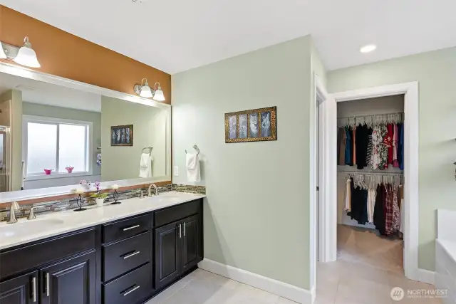 Primary Bathroom with dual sinks and walk-in closet
