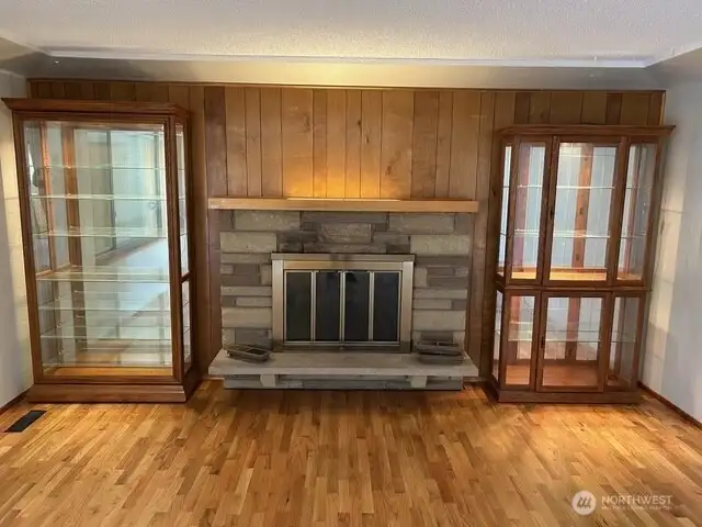 Lighted cabinets and fireplace in living room