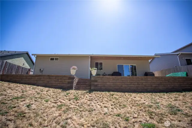 view of the back of home from the terraced yard