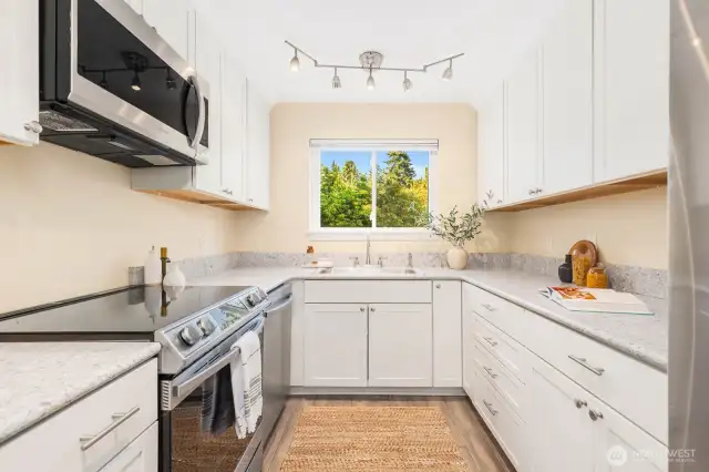 Upgrades continue throughout the kitchen, custom lighting and new appliances