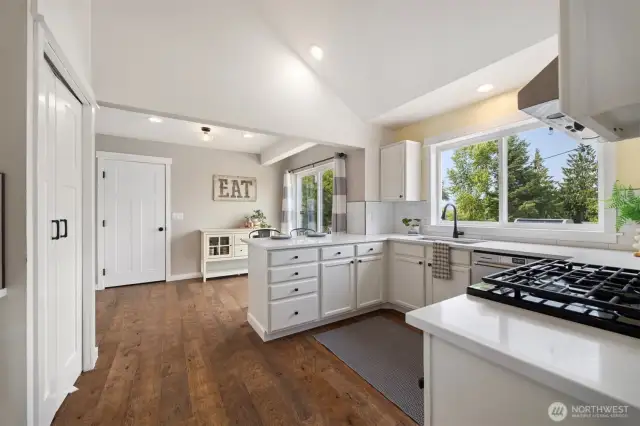 You'll love how bright the kitchen is, with white quartz counters, fresh white cabinetry and lots of light. The door straight ahead leads into the garage.