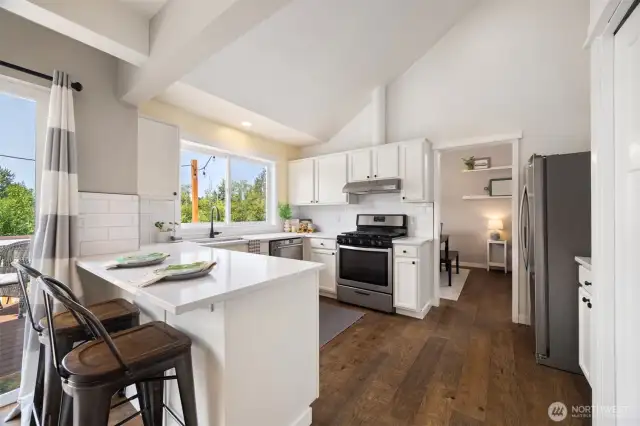 You'll love how open the kitchen is, with it's vaulted ceilings, bright natural lighting and fresh white cabinets.