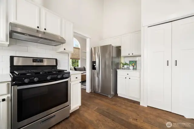 The kitchen flows into the dining & living room, with pantry storage in the double doors.