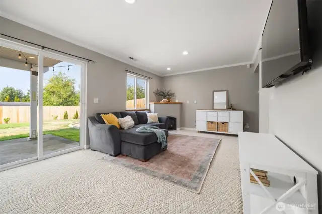 The bonus room includes sliding glass doors out into the backyard and a fireplace for cozy movie nights.