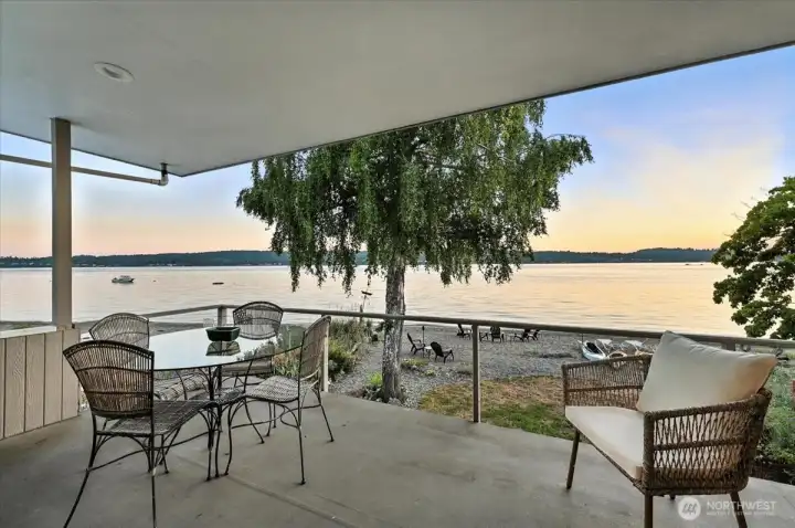 Primary deck blends horizon and sea, offering sweeping sandy beach views framed by vibrant sunsets. A coastal retreat where sky meets shoreline in nightly brilliance.