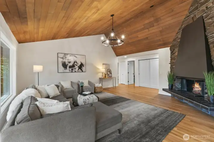 Relax and get cozy around the fireplace. Wall of windows looks out to your own evergreen sanctuary!