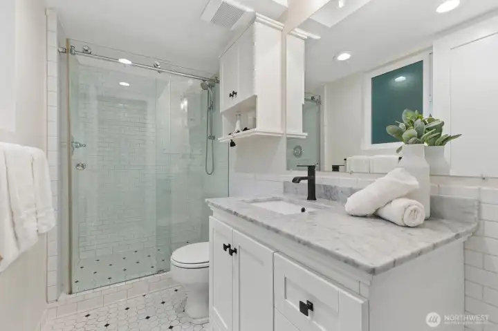 this Primary 3/4 bath is fresh, cheery and bright.