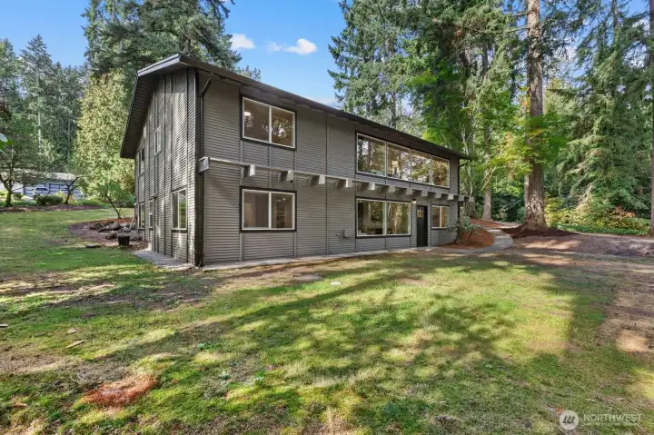 Back side of the home. This 38+K Square Foot lot is sunshine dappled and provides multiple areas for a future garden.