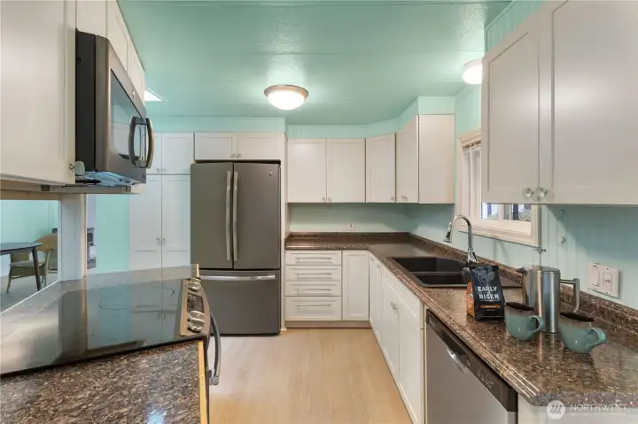The updated kitchen with enough counter space to keep your favorite chef busy. Look at all that storage space!
