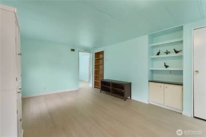 Looking from the kitchen through the living area and into the primary bedroom
