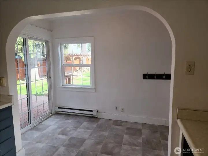 Eat-in area space with slider leading to the back deck.  To the right of the photo is a door leading to the garage.