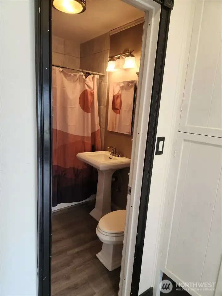 From the living room is a hallway leading to the bathroom.