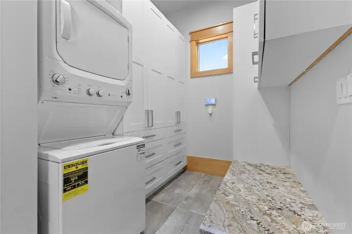 Main floor laundry/mud room with tons of cabinets