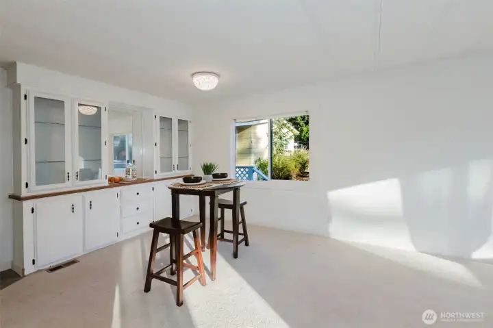 Dedicated dining space featuring built-in cabinetry for added storage and display, with natural light pouring in from nearby windows.