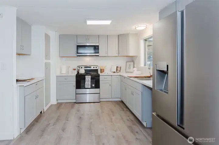 Remodeled kitchen with updated cabinetry, modern finishes, and stainless steel appliances, designed for both functionality and style.