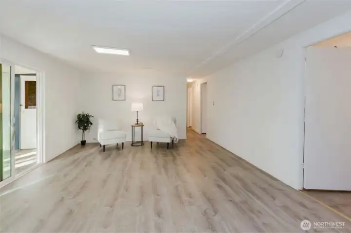 Large bonus living area with durable flooring, ideal for a media room, hobby space, or additional gathering area.