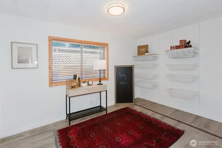 Versatile room with natural light, suitable for use as a bedroom, home office, or hobby space.