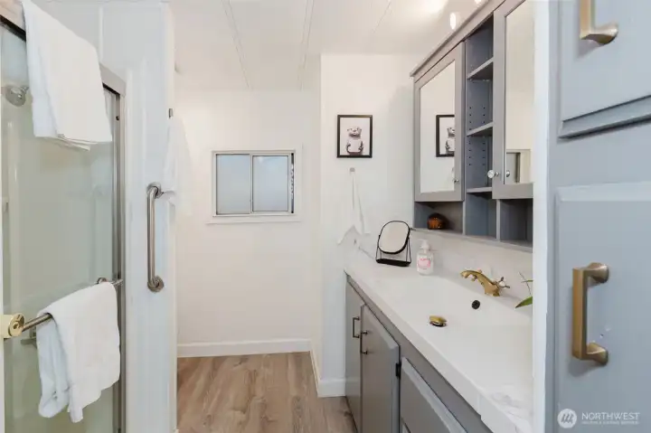 Large bathroom with built in vanity space, storage, and updated fixtures.