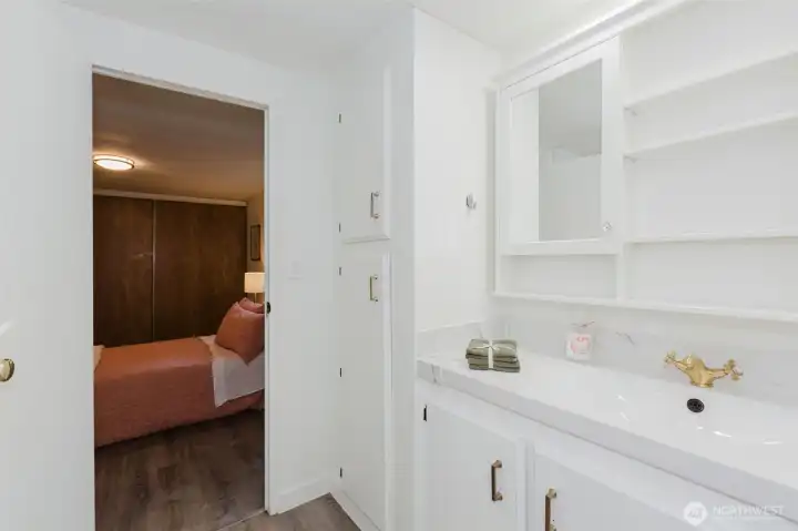 Bright ensuite bathroom with updated vanity, storage, and clean, modern finishes.