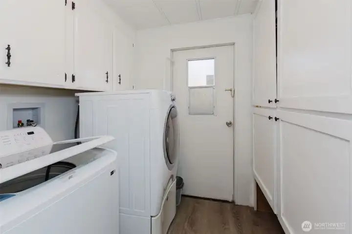 Functional laundry area with built-in storage and convenient exterior access.