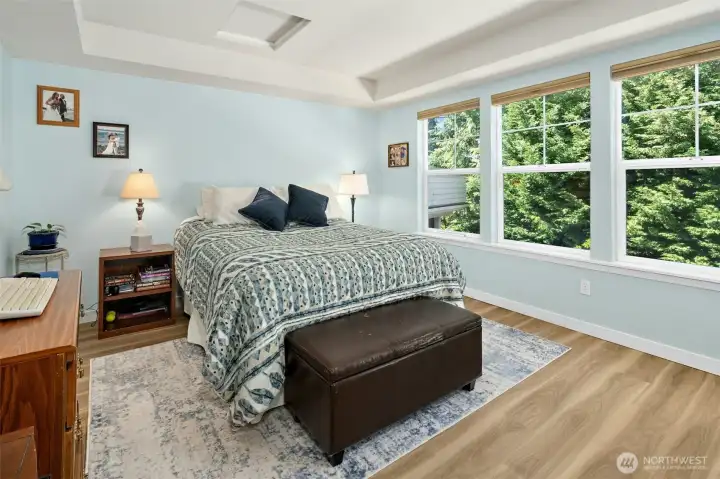 Spacious primary bedroom with tons of natural light.