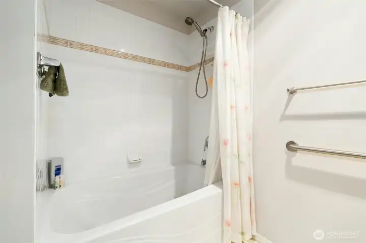 Primary bathroom tub/shower combo.  So easy to convert to a walk-in shower if needed.  Plenty of space to move around.