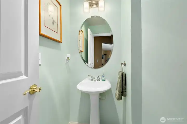Half bath located in hallway for guests.
