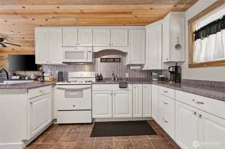 Thoughtful upgrades- stainless steel backsplash & knotty pine ceilings!