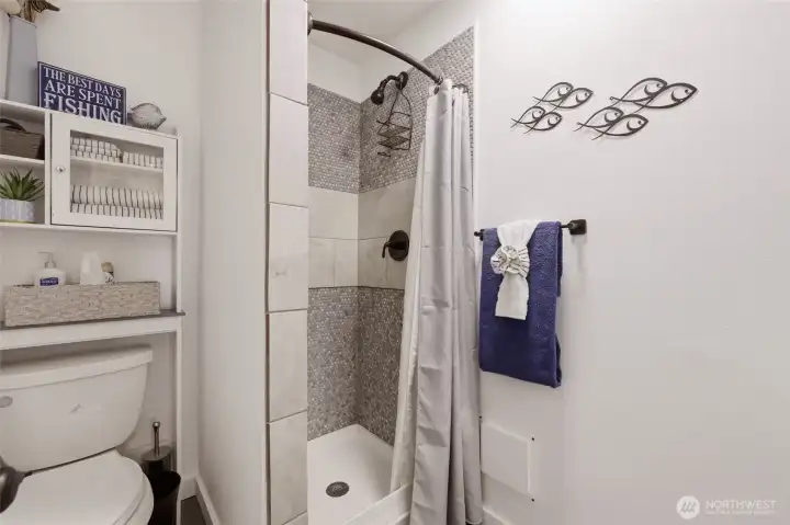 Completely redone- nice tiled shower- comfort height commode- all LAKE Theme items are a part of staging.