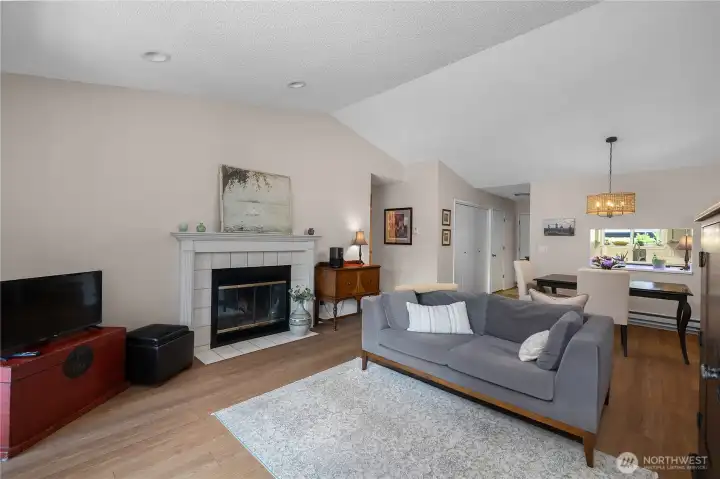 Open concept living space with bedrooms directly off hallway. Primary suite to left, guest bedroom to right.