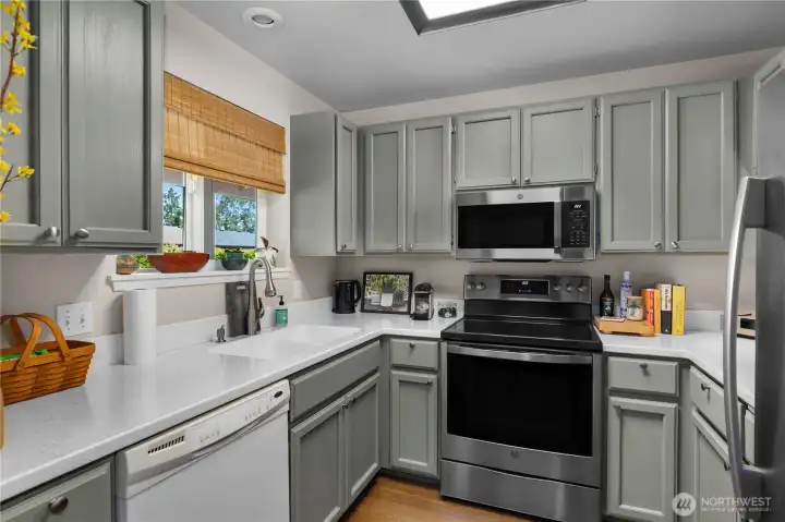 Beautiful kitchen with newer appliances and freshly painted cabinetry.
