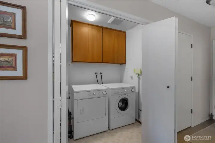 Over-sized laundry space with additional storage.