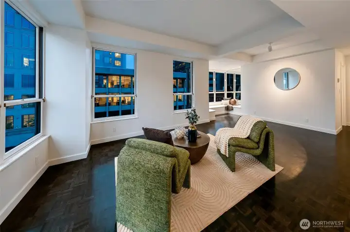 The living room of #701 brings city light and outlooks directly into everyday life.
