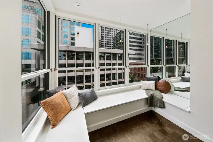 View from #701: The built-in banquette sits directly along the window line, overlooking First Avenue and the surrounding city.