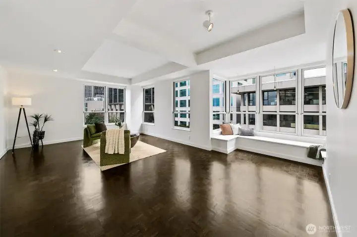 From the living and dining room of #701, broad windows frame the architecture and movement of downtown Seattle.