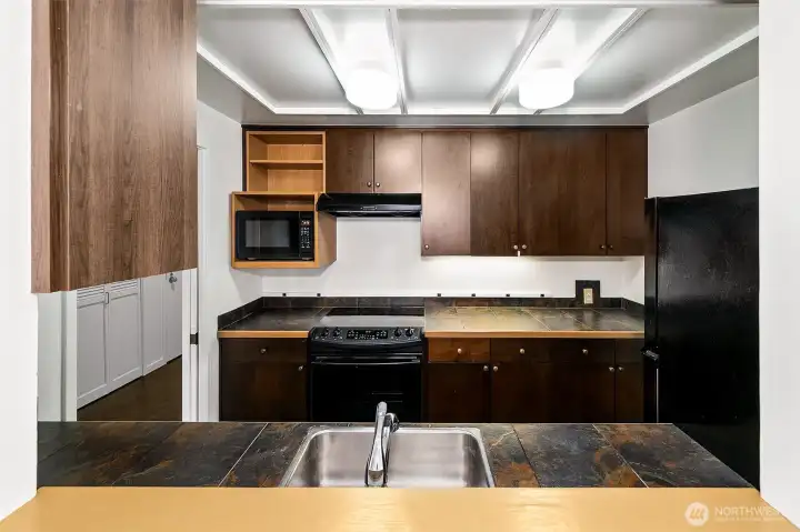 The kitchen pass-through keeps cooking, serving and conversation connected to the main living and dining space.