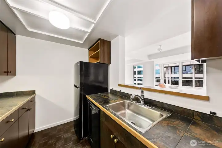 A practical, well-kept kitchen positioned just off the foyer and open to the living and dining room.