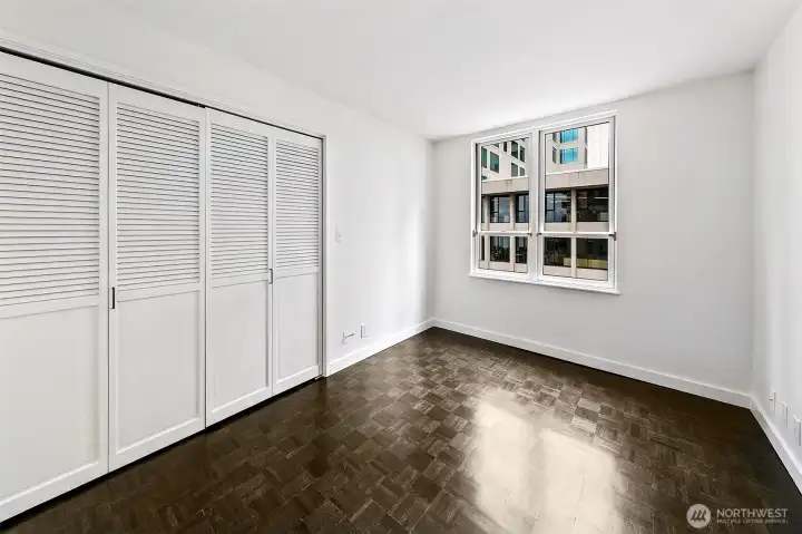 The separate bedroom of #701 has generous closet storage, oak floors and its own city outlook.