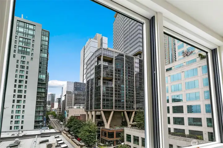 View from #701: The bedroom looks directly into the architecture and daily movement of downtown Seattle.