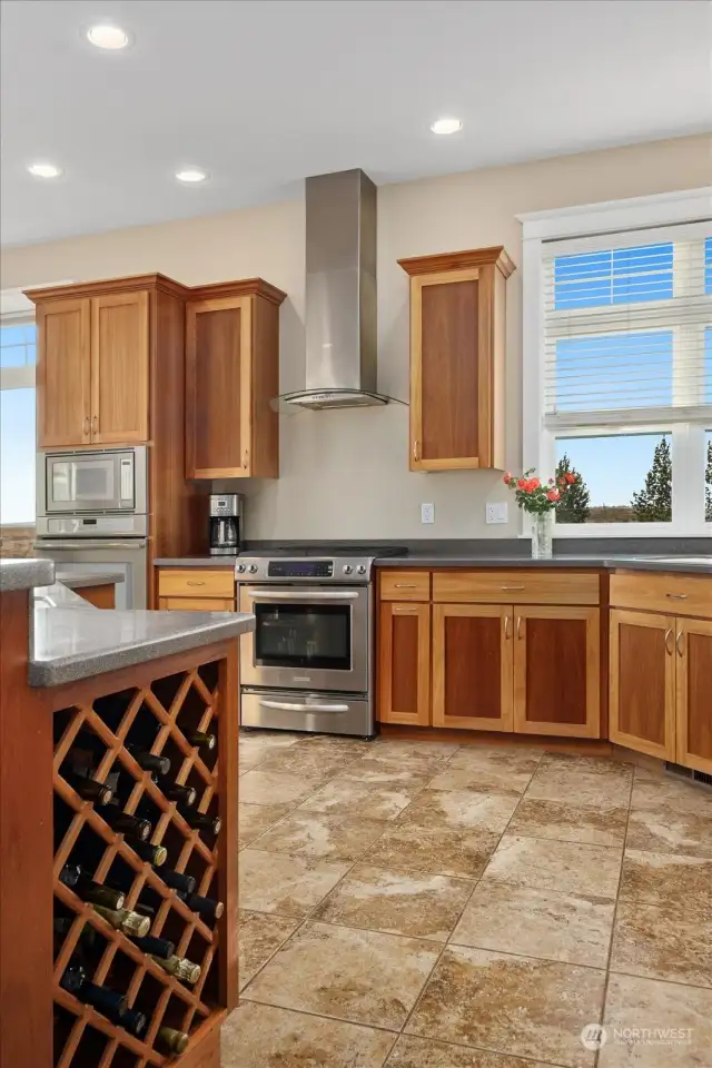 Kitchen custom features include cabinetry, gas stove, wine rack