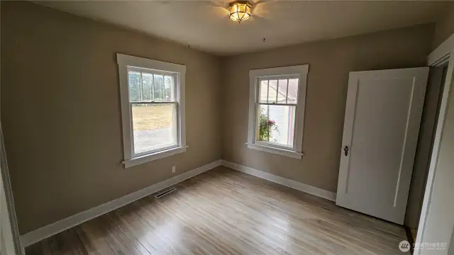 downstairs bedroom with refinished floors.