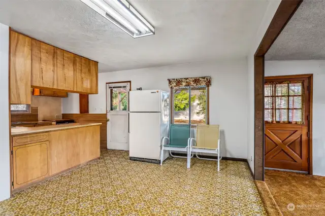 Dining area; kitchen in background; step down to living area.