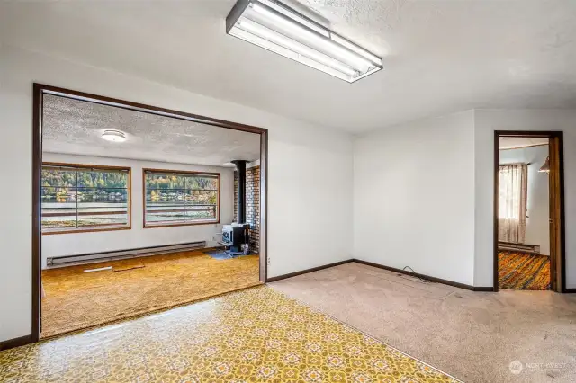 Dining area is spacious and adjacent to living room with wood stove.