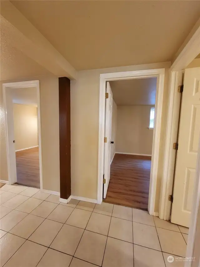 Door to left is access to 1st bedroom. Door to straight ahead is access to 2nd bedroom. Door to right is to Den/office/large storage.