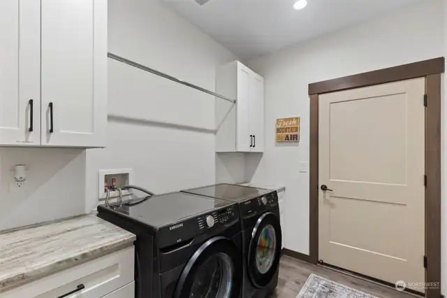 Laundry room with appliances included leading to garage.