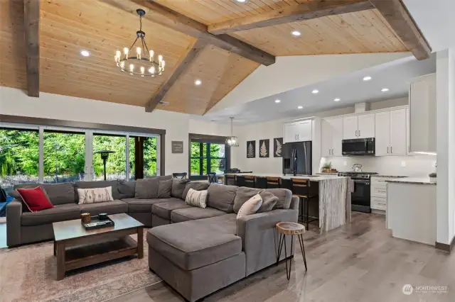 Open concept modern layout with custom vaulted tongue and groove ceiling feature.