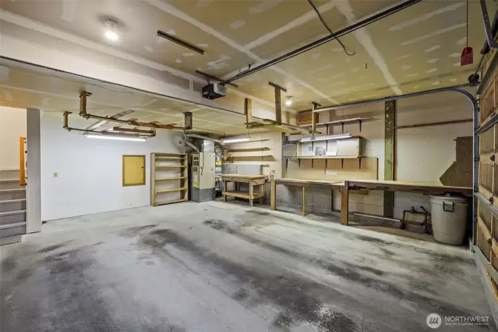 Two car garage with work space. Freshly painted stairs to living space.