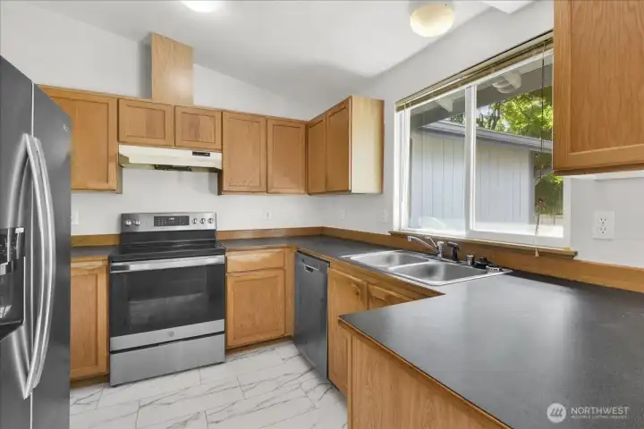 The kitchen has stainless appliances and lots of cabinets and counter space.