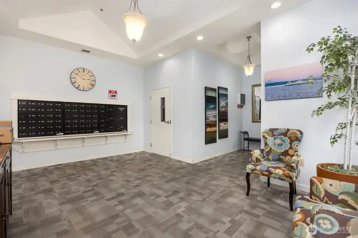 The lobby has a secure entrance, with mailboxes and seating area.